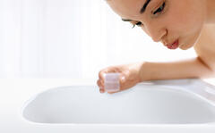 Woman rinses her mouth with an antiseptic mouthwash solution